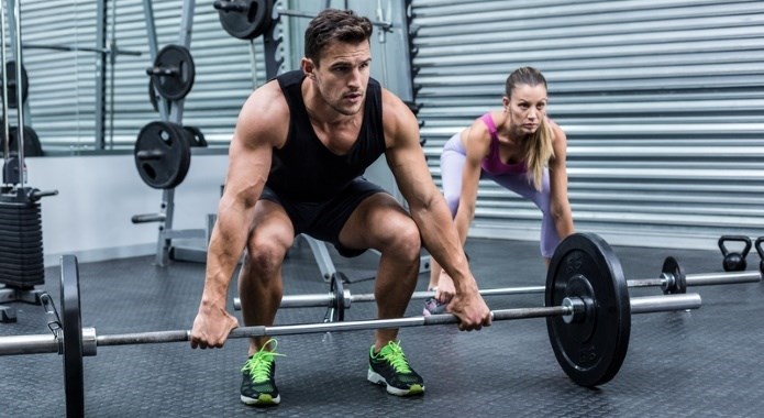 woman and man lifting weights