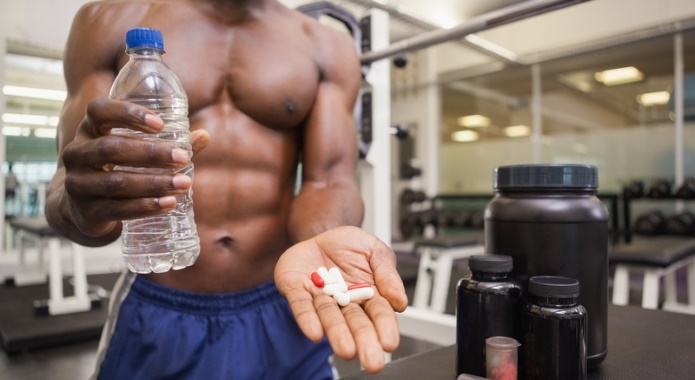 fitness guy with fat burning pills