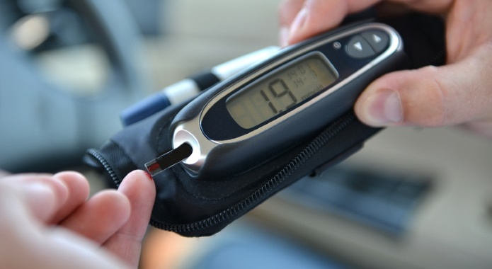 man measuring blood sugar