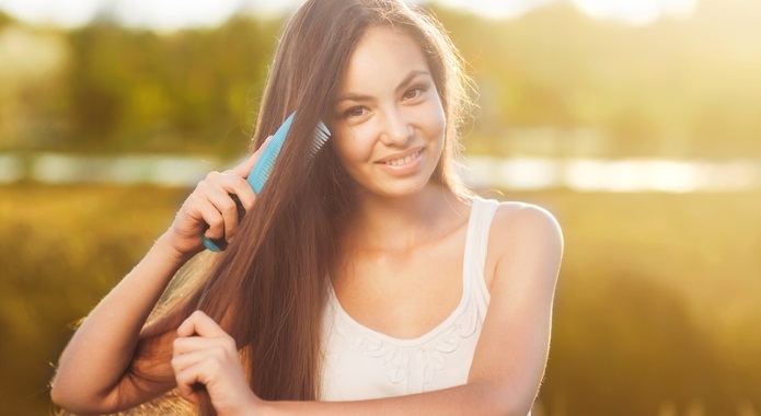 young girl combing her hair