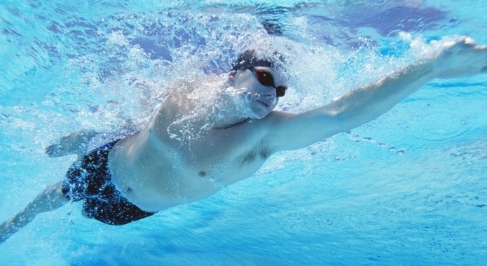 young-man-swimming-min